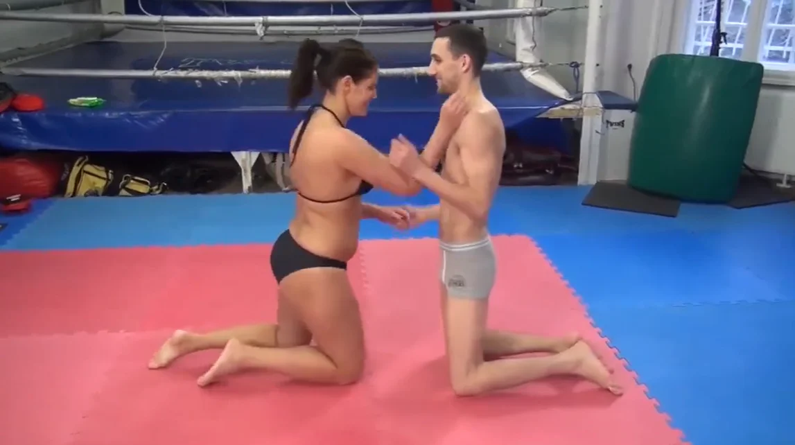 grappling session between fit woman and strong man