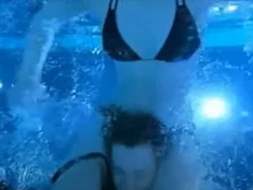 strong lady in bikini wrestles man in pool