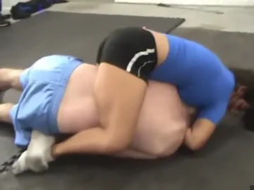 intense mixed wrestling match between young woman and man
