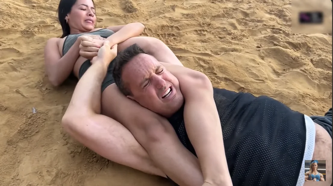 woman wrestles man competitively