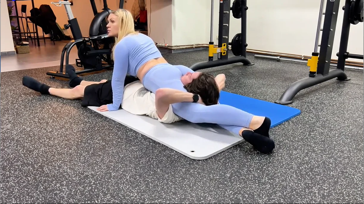 fitness instructor flexes her scissorhold leg strength