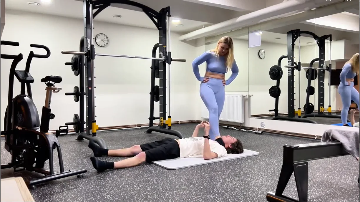 fitness instructor flexes her scissorhold leg strength