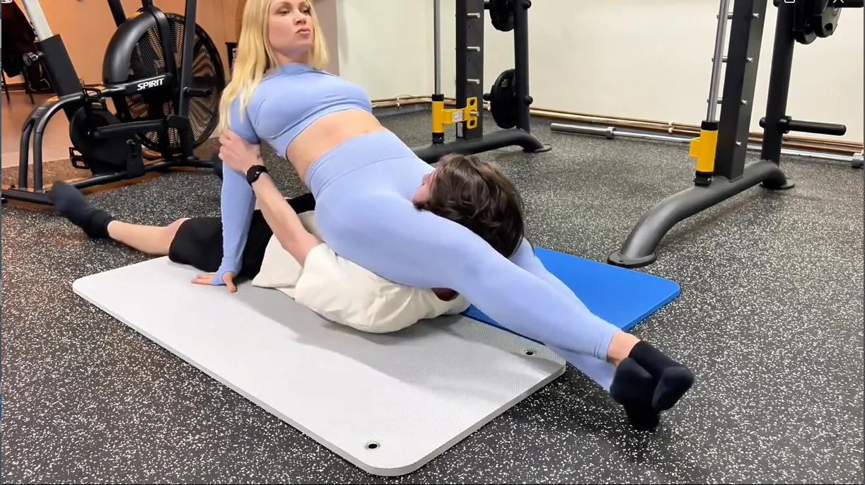 fitness instructor flexes her scissorhold leg strength