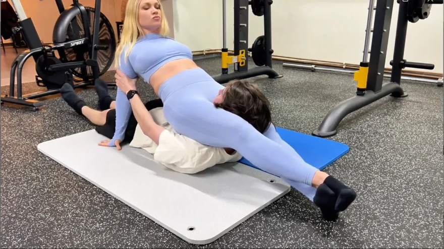 fitness instructor flexes her scissorhold leg strength