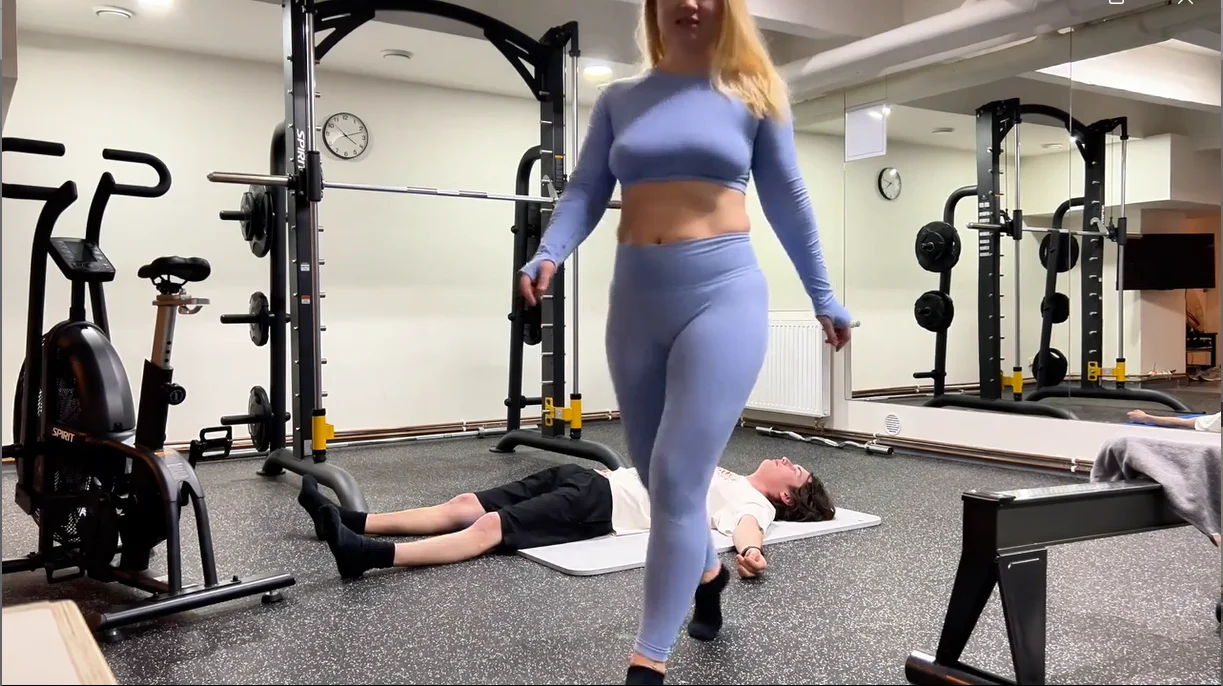 fitness instructor flexes her scissorhold leg strength